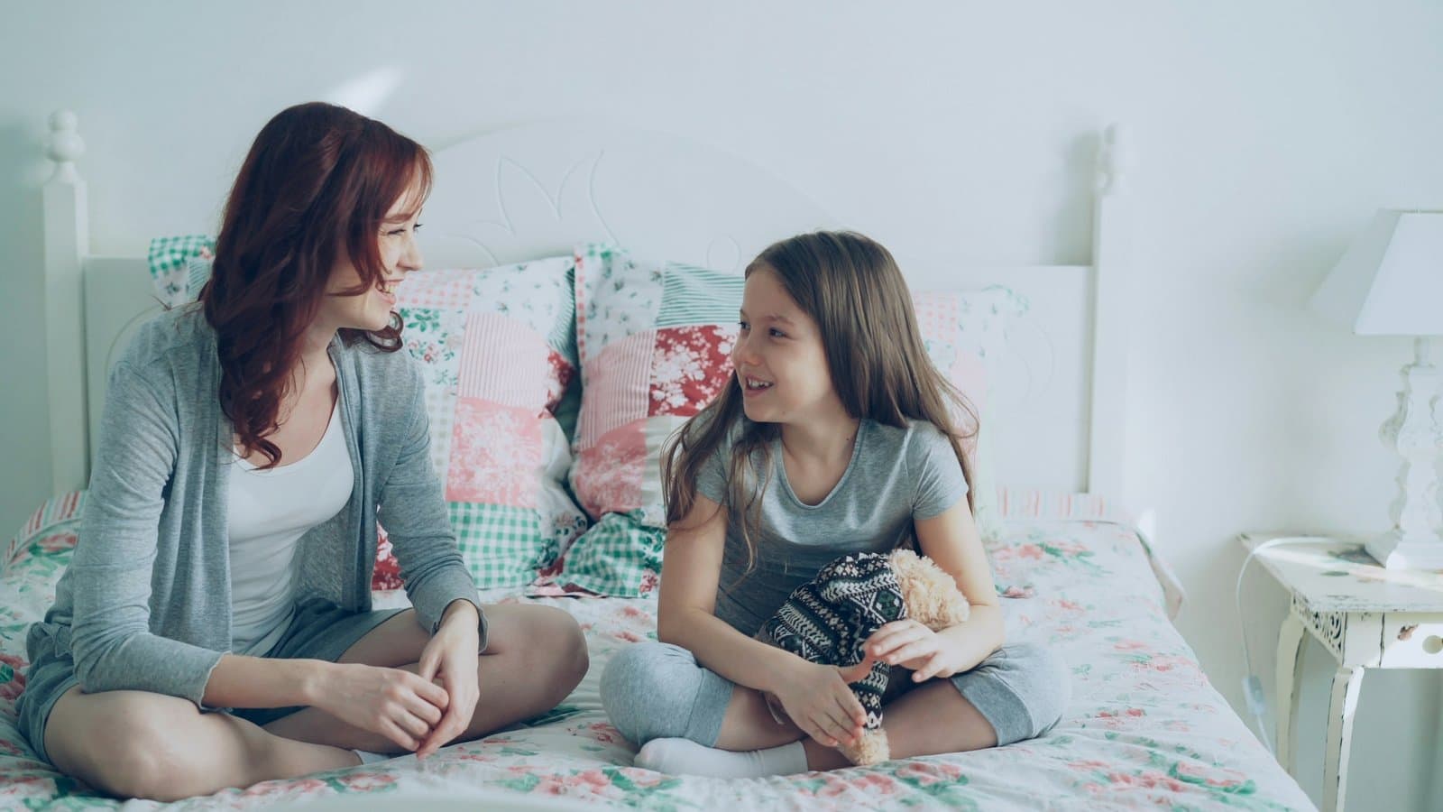 A parent and child talking and smiling together at home